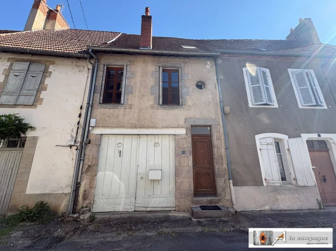 Mid-Terraced Village House with Strong Potential, a Garage, and an Enclosed Garden.